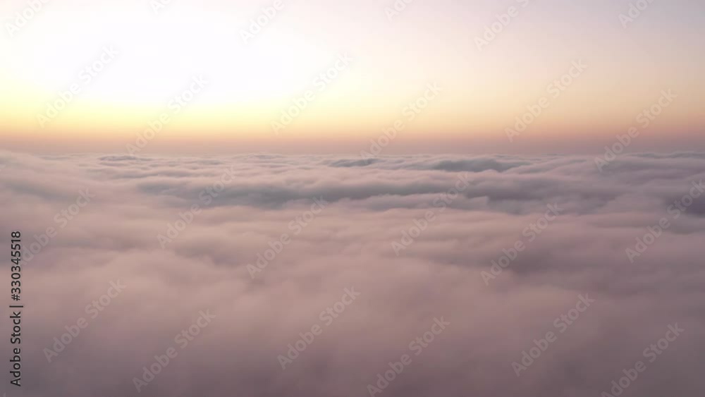 Drone flying over thick fog clouds at dawn. Liwa desert, Abu Dhabi, United Arab Emirates. Drone flying over thick fog clouds at dawn. Liwa desert, Abu Dhabi, United Arab Emirates.
