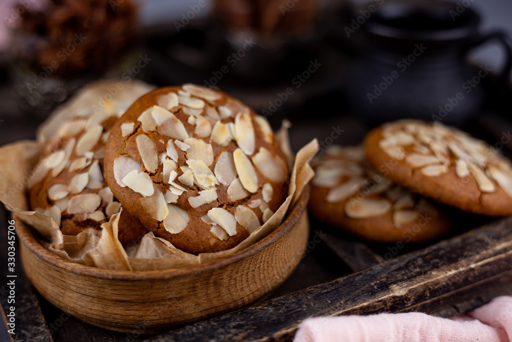 Sweet almond cookies  on wooden table.French homemade cookie. Useful Lenten cookies from almond flour with honey on rustic wooden background. Selective soft focus.