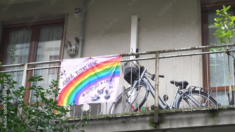 Europe, Italy, Milan March 2020, Coronavirus emergency - On the windows of the city hang sheets designed by children with rainbow and the words 