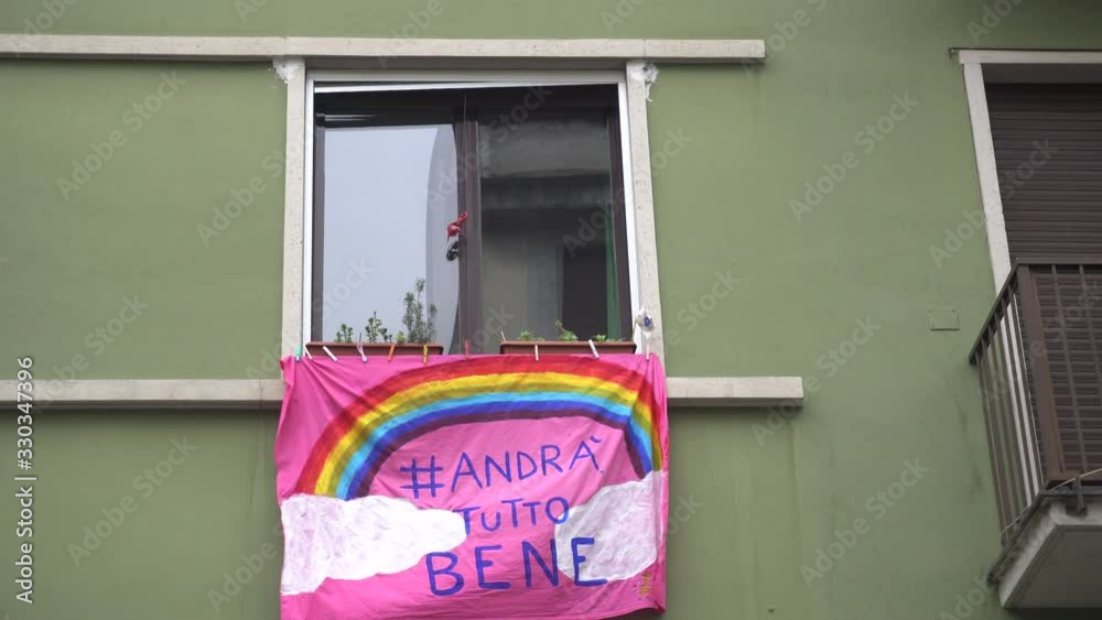 Europe, Italy, Milan March 2020, Coronavirus emergency - On the windows of the city hang sheets designed by children with rainbow and the words 