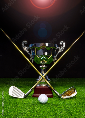 Golf club with golf ball and a golf trophy on the turf