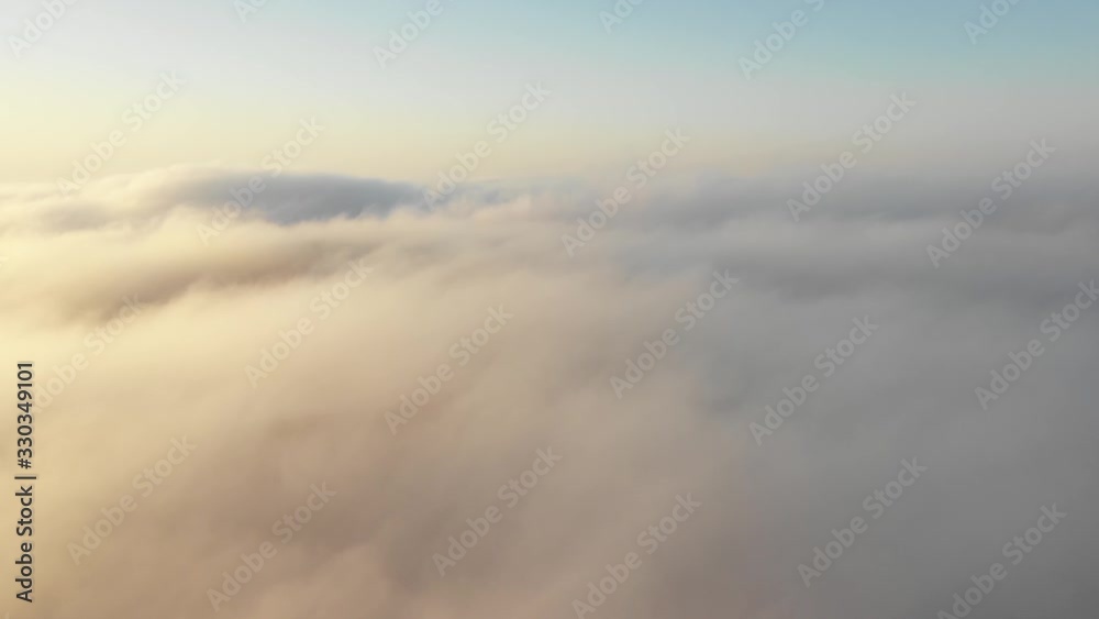 Drone flying over thick fog clouds at sunrise. Liwa desert, Abu Dhabi, United Arab Emirates. Drone flying over thick fog clouds at sunrise. Liwa desert, Abu Dhabi, United Arab Emirates.
