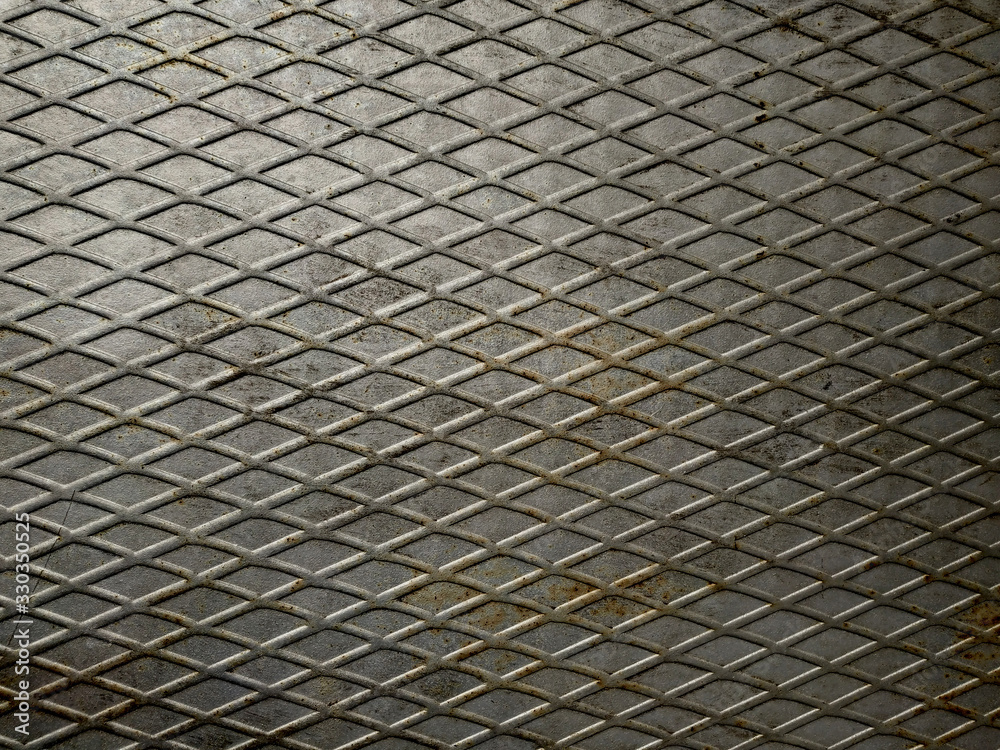 Rusty gray metal texture with a diagonal mesh. Shallow grid of steel wall texture. Speaker grill texture.Background for grunge design poster, invitation, cheeky party. Rusty gray metal texture with a diagonal mesh. Shallow grid of steel wall texture. Speaker grill texture.Background for grunge design poster, invitation, cheeky party.