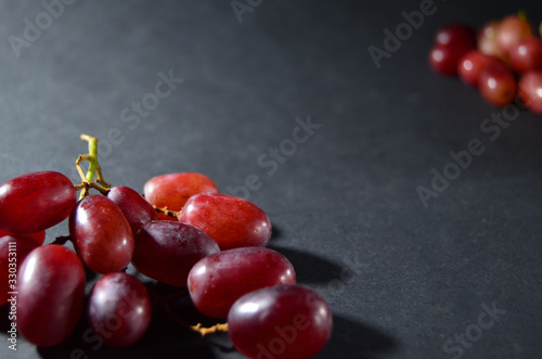 red grape lies on the table frame with a copy space on a gray background horizontal orientation