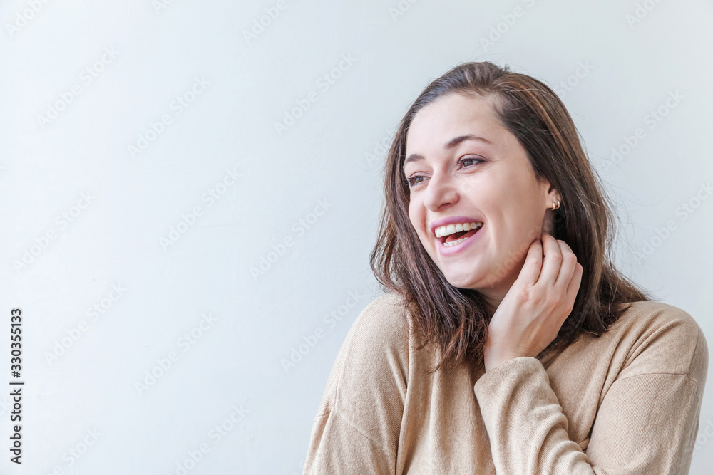 Happy girl smiling. Beauty portrait young happy positive laughing brunette woman on white background isolated. European woman. Positive human emotion facial expression body language Happy girl smiling. Beauty portrait young happy positive laughing brunette woman on white background isolated. European woman. Positive human emotion facial expression body language