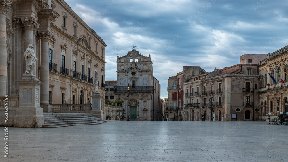 Main square of Ortigia island in cloudy day and view of the catholic church Santa Lucia in Badia in province of Syracuse in Sicily
