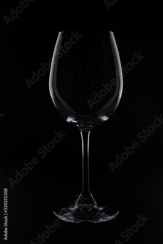 empity red wine glass on black background