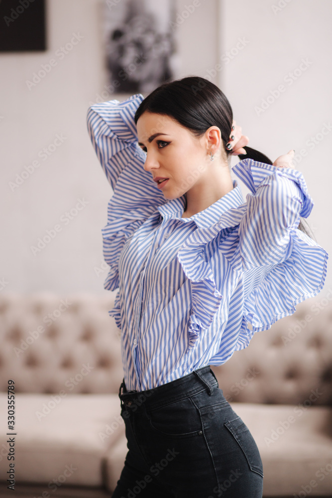 Attractive young model demonstrating clothes. Spring colections on elegant brunette woman. Demin style