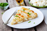 Traditional feta cheese phyllo pastry pie, banitsa. Wooden background. Close up.