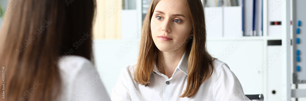 Portrait of smart businesswoman discussing important and profitable contract. Colleagues sitting in modern workplace and discussing new start-up. Accounting office concept Portrait of smart businesswoman discussing important and profitable contract. Colleagues sitting in modern workplace and discussing new start-up. Accounting office concept