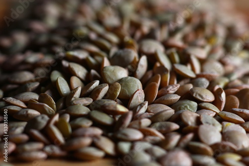 lentil grains scattered on a wooden surface