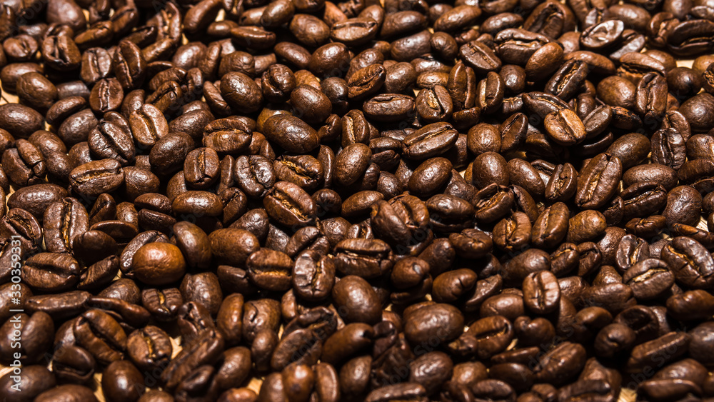 Dark roasted coffee beans for background, wallpaper, and design concept for food and drink themed photography. Dark roasted coffee beans for background, wallpaper, and design concept for food and drink themed photography.