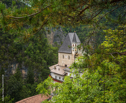 Sanctuary of San Romedio dedicated to Saint Romedius situated on a steep rocky spur in the natural scenery of the Val di Non, Trentino, Italy   photo