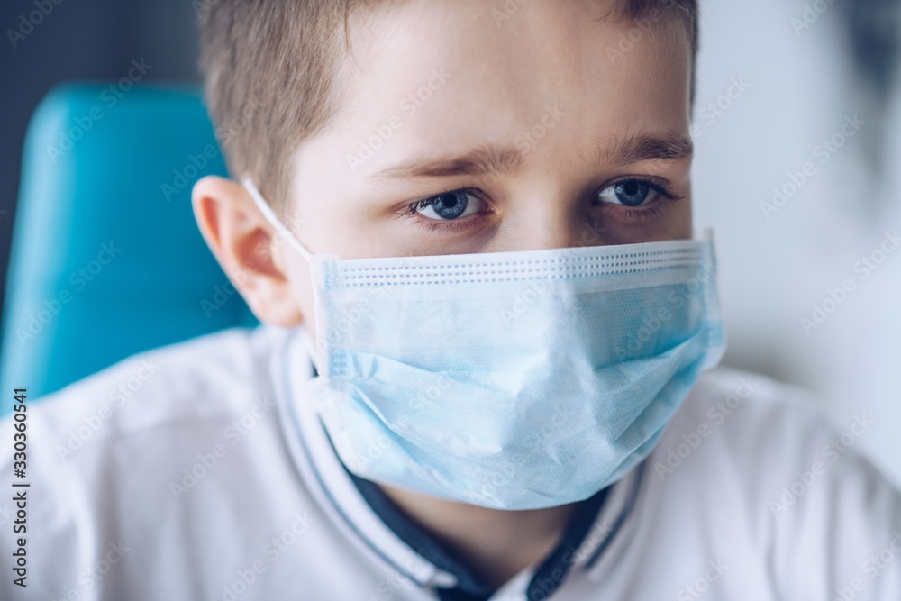 Sad boy in medical protective mask. Child during coronavirus epidemic Sad boy in medical protective mask. Child during coronavirus epidemic
