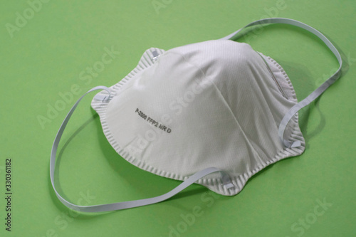 Surgical mask with rubber ear straps. FFFP2 green background photo