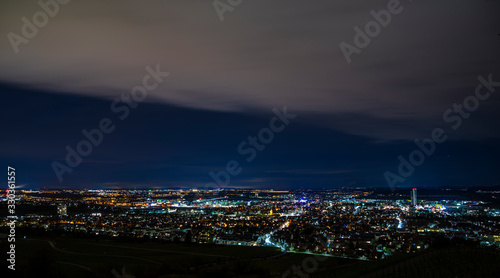 Germany, Panorama aerial view above houses, skyline, tower and streets of fellbach city near stuttgart, illuminated lights by night