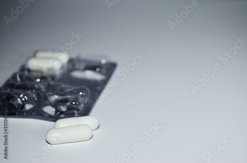white tablets and used packaging on a white background with copy space