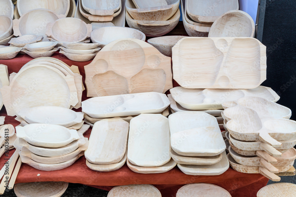 Hand made food choppers made of raw wooden, displayed for sale at an weekend street food market, traditional Romanian wood craftsmanship