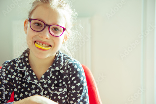 Portrait of little sick child in mask with lemon and at quarantine becouse of coronavirus photo