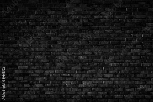 Old black and white brick wall background texture.