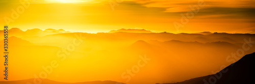 Panorama of Yellow Sunset in Mountains