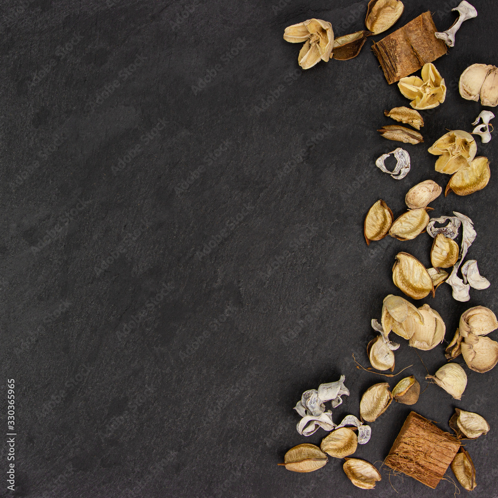 Dried aroma flowers on the dark textured background. Aromatic Flower fragrance on black background. Dried aroma flowers on the dark textured background. Aromatic Flower fragrance on black background.