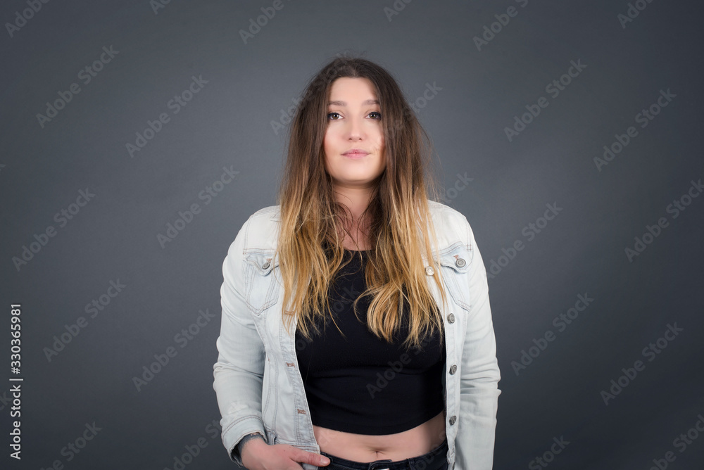 Young brautiful woman wearing white sweater over isolated background happy face smiling with hands in pockets looking at the camera. Positive person. Young brautiful woman wearing white sweater over isolated background happy face smiling with hands in pockets looking at the camera. Positive person.