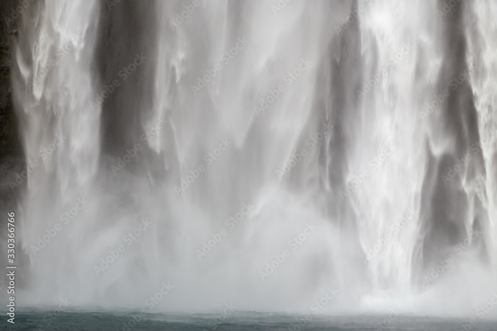Close-up of powerful falling water at Skogafoss waterfall in Iceland Close-up of powerful falling water at Skogafoss waterfall in Iceland