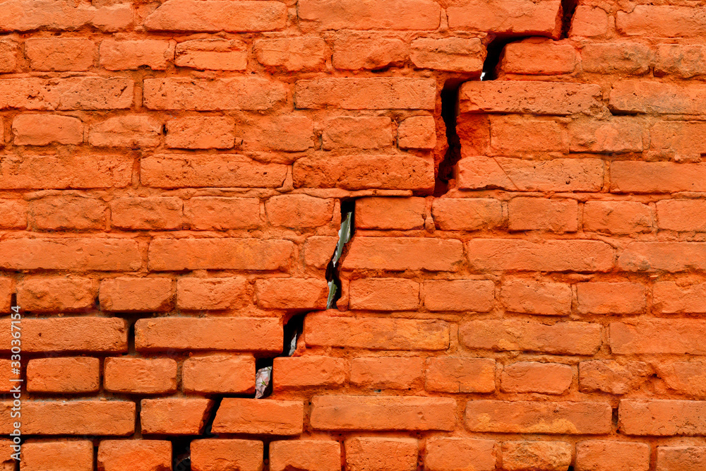 Obraz premium Old Weathered Cracked Orange Painted Brick Wall Texture