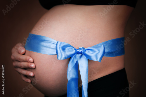 Wallpaper Mural Pregnant girl with a blue ribbon around her belly Torontodigital.ca