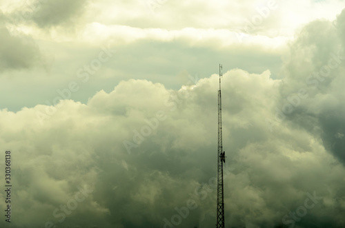 Communications tower pointing through clouds