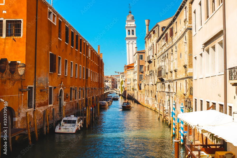 A nice canal with tourists sailing from Venice. Italy