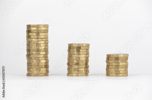 Descending stacks of new £1 pound coins graph on a white background. 