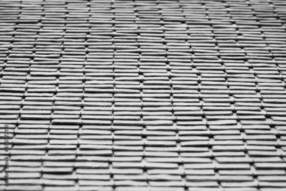 Black and white photo of a roof tile texture