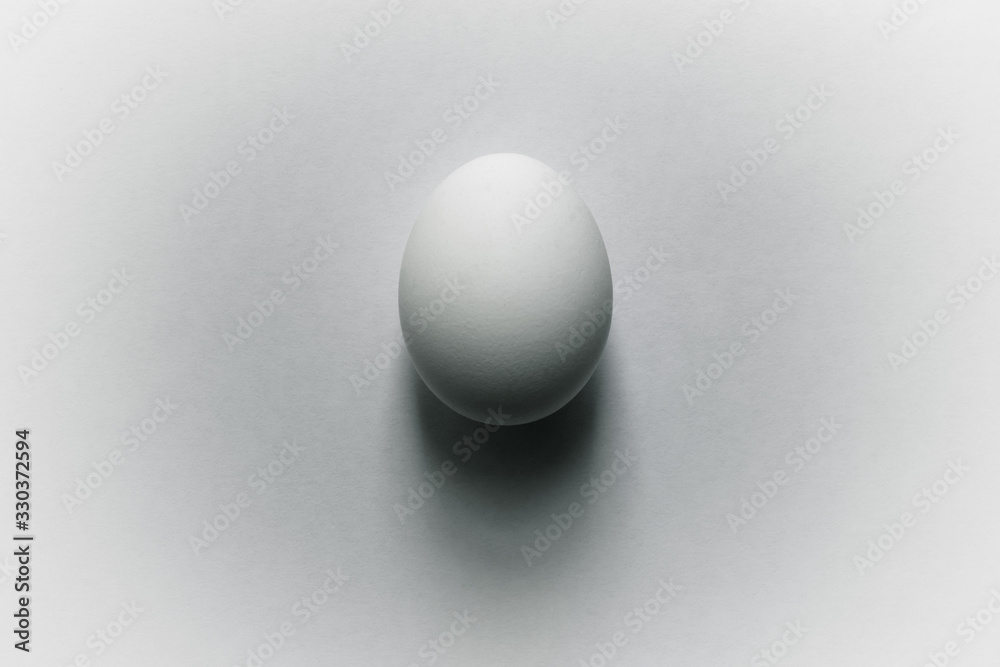 White egg with shadow on a white background White egg with shadow on a white background