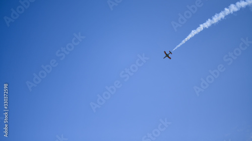 the plane against the blue sky flies from the upper right corner