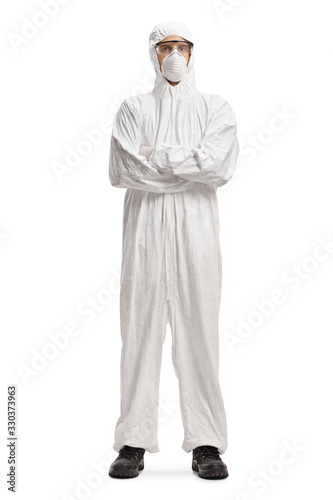 Man wearing a decontamination suit and mask and posing with crossed arms photo