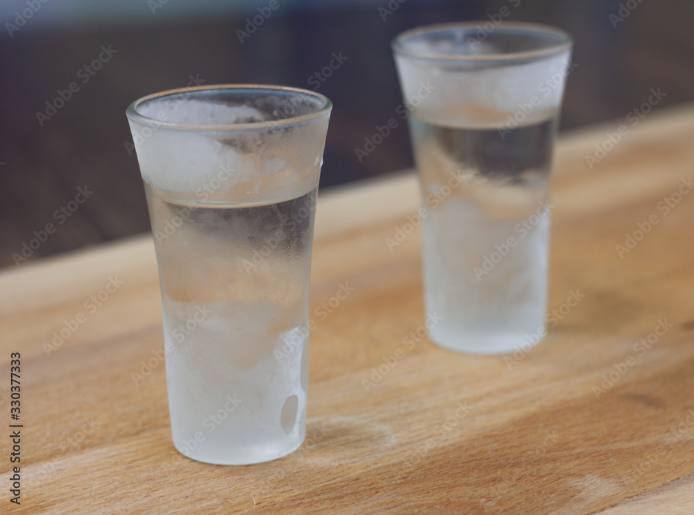 ice-cold vodka on a wooden counter. alcohol ice-cold vodka on a wooden counter. alcohol