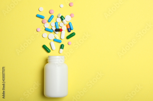 pills on a colored background top view. Medicine, treatment, illness. Medication in tablets.
