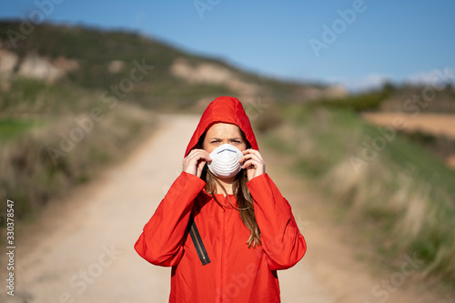 Woman with a mask dressed in a red NBQ suit. photo