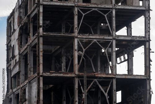 Frame of an old destroyed industrial building. © delobol