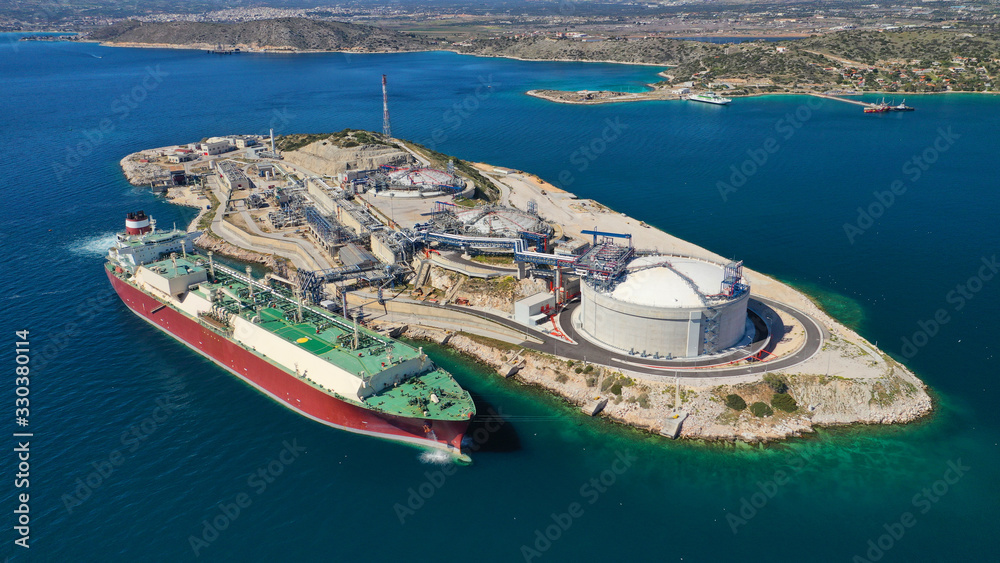 Aerial drone photo of of small industrial islet and Natural Gas Terminal Station in Mediterranean, Elefsina, Greece