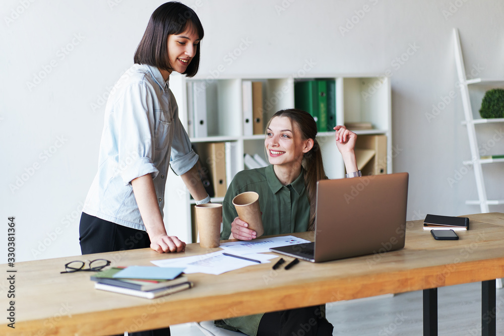 Happy pretty businesswomen having a meeting in office Happy pretty businesswomen having a meeting in office