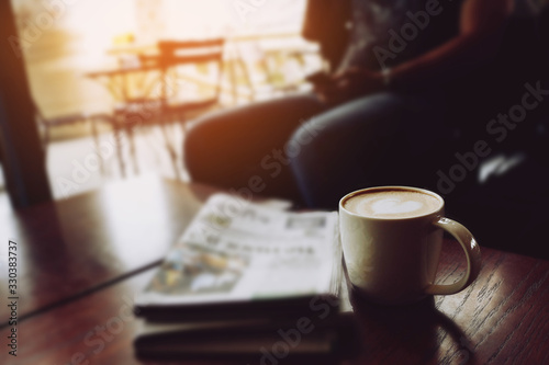 Fototapeta Latte coffee on coffee shop with heart pattern in a white cup on wooden table in cafe background