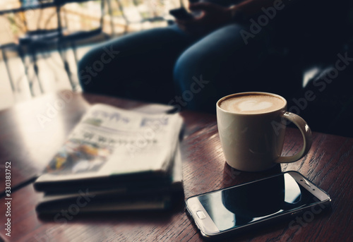 Fototapeta Latte coffee on coffee shop with heart pattern in a white cup on wooden table in cafe background