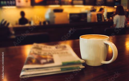 Fototapeta Latte coffee on coffee shop with heart pattern in a white cup on wooden table in cafe background