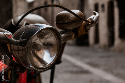Handlebar, headlight and bell of an old bicycle.