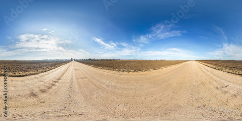 full seamless spherical hdri panorama 360 degrees angle view on gravel road among fields in spring day with awesome clouds in equirectangular projection, ready for VR AR virtual reality content