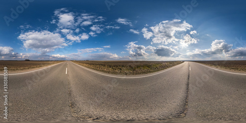 Full spherical seamless panorama 360 degrees angle view on no traffic asphalt road among fields in sunny day with cloudy sky. 360 panorama in equirectangular projection  VR AR content