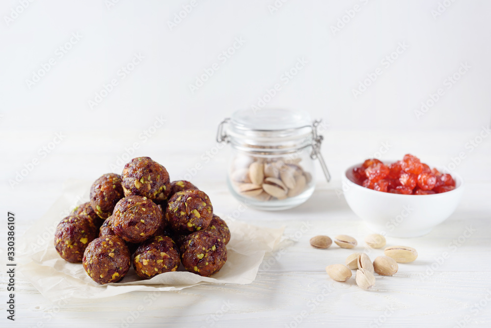 Energy balls with dried apricots, raisins, pistachios and dried cherrys. Vegan food. White